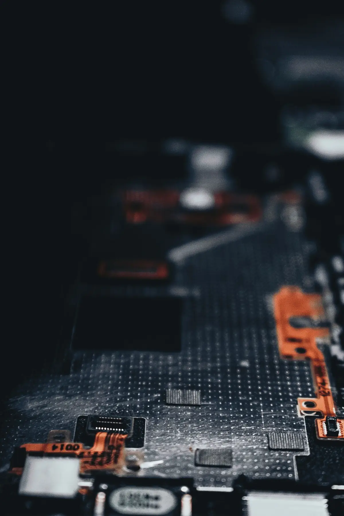 Close-up of a dark circuit board with electronic components
